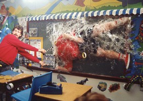 Photo of Eric Edwards about to get taped up on chalkboard