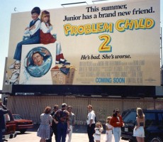 Ivy and John Ritter on set with the Problem Child movie poster behind them